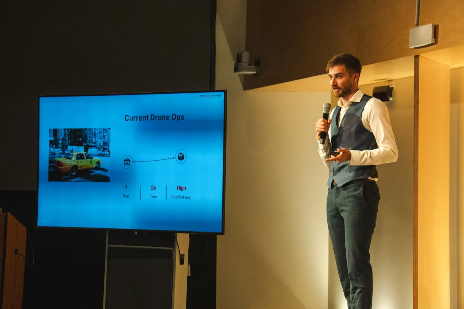 Jakob pitching Grasshopper on stage at the Draper University demo day, May 2026.