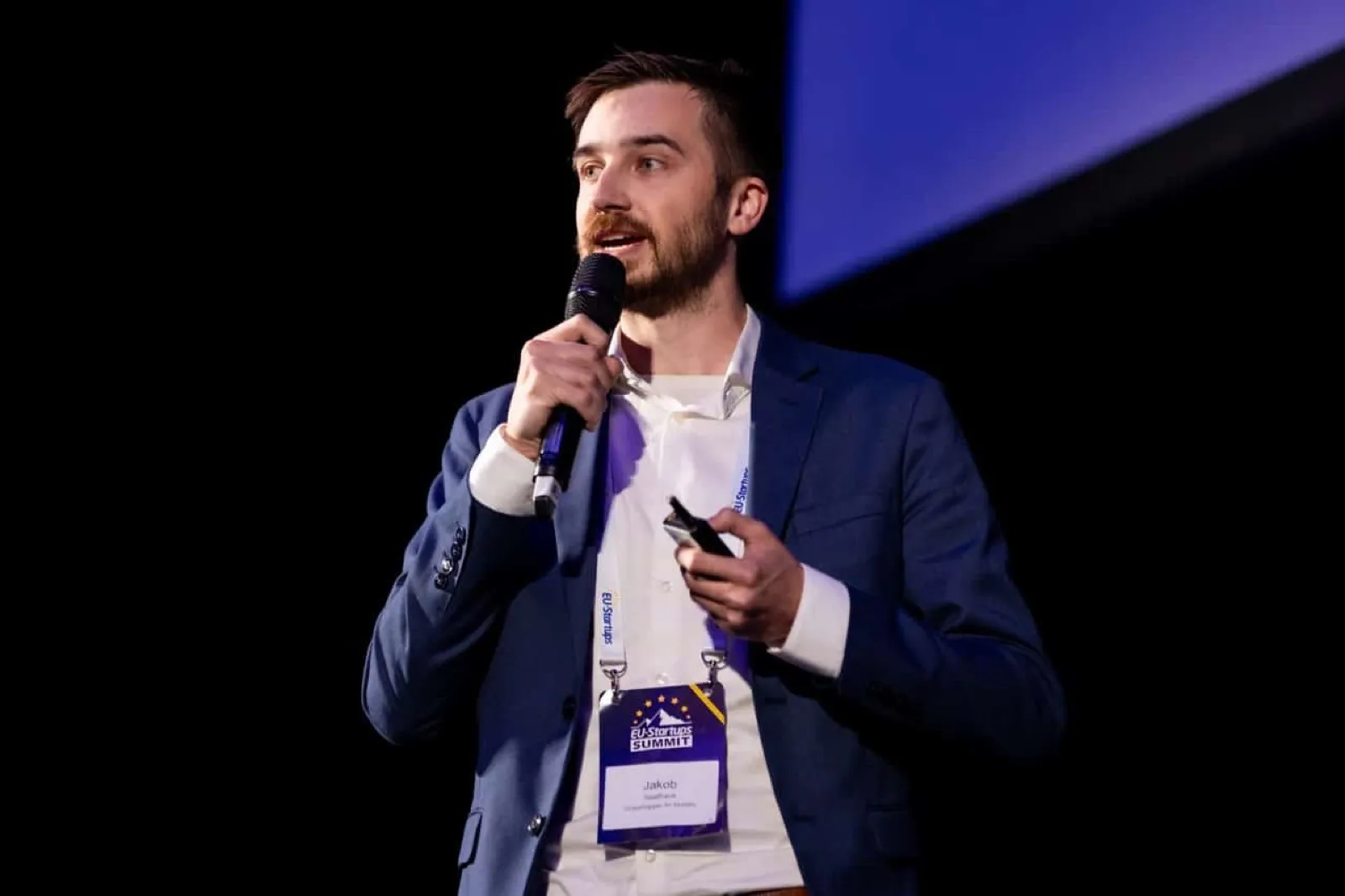 Jakob pitching with a microphone at the EU-Startups Summit pitch finals in Malta, April 2025.