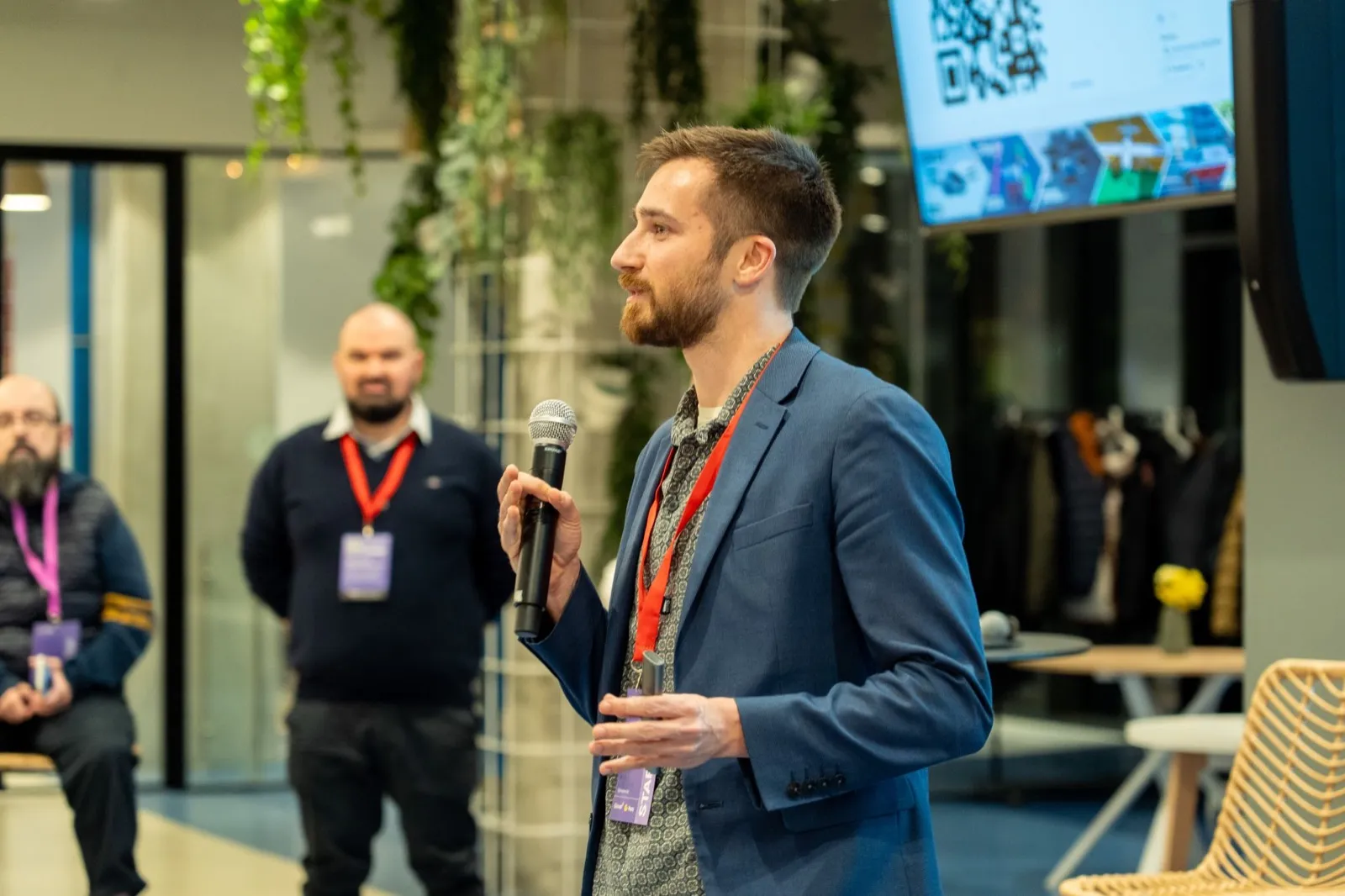 Jakob speaking into a microphone at a startup event during MWC week in Barcelona, March 2026.